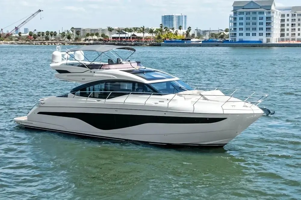 A white motor yacht cruising emerald water off Destin