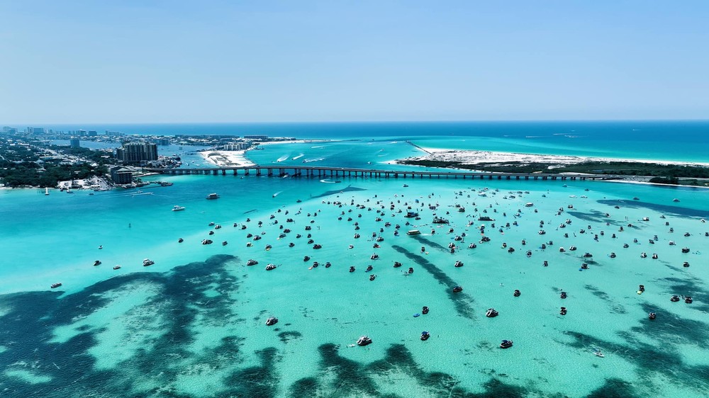 The Crab Island sandbar crowded with anchored boats, seen from above