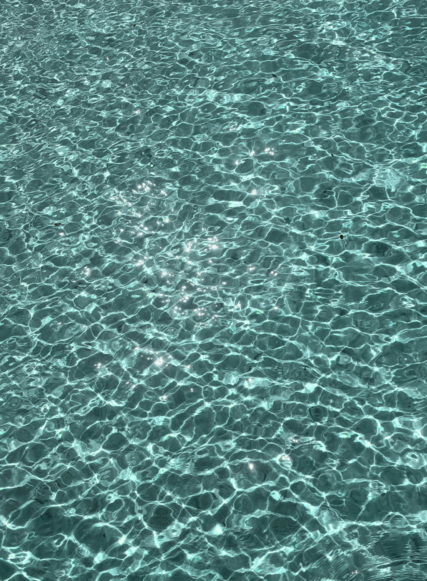 Sunlight rippling on clear turquoise water
